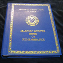 The Provincial Grand Lodge of Sussex, Masonic Widows Remembrance Book, Blue Leather with gold embossed logo, decorative border & type. Hand written entries & botanical illustrations throughout